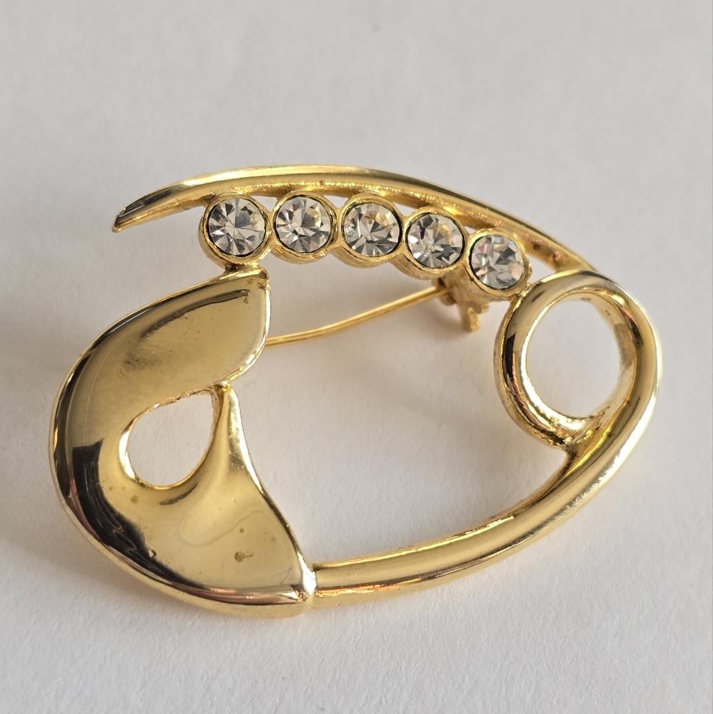 Vintage brooch shaped like a safety pin Gold tone metal sparkly clear gems